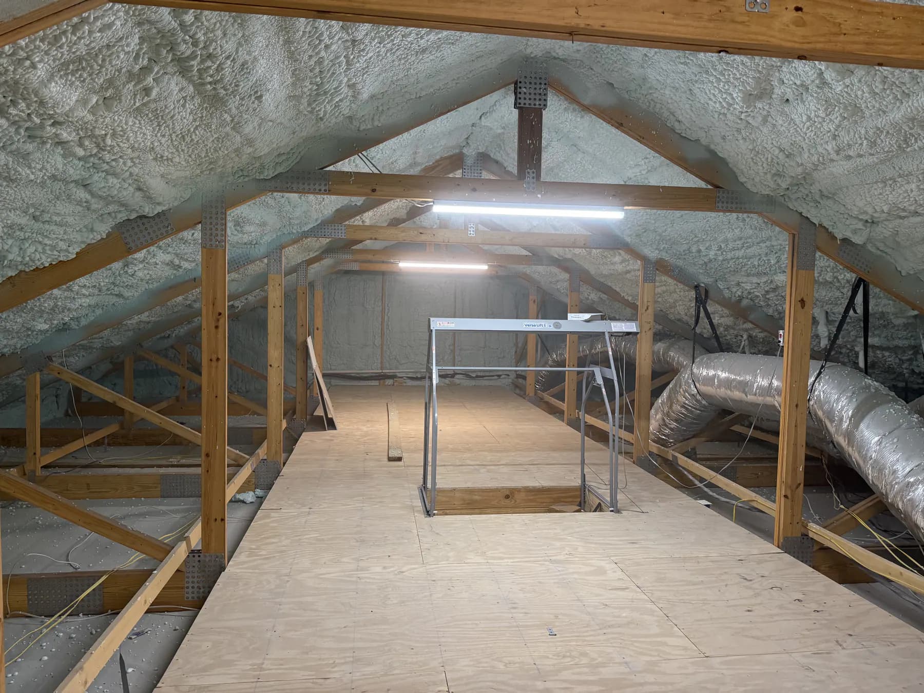 Completed open-cell spray foam installation along a residential attic roof deck